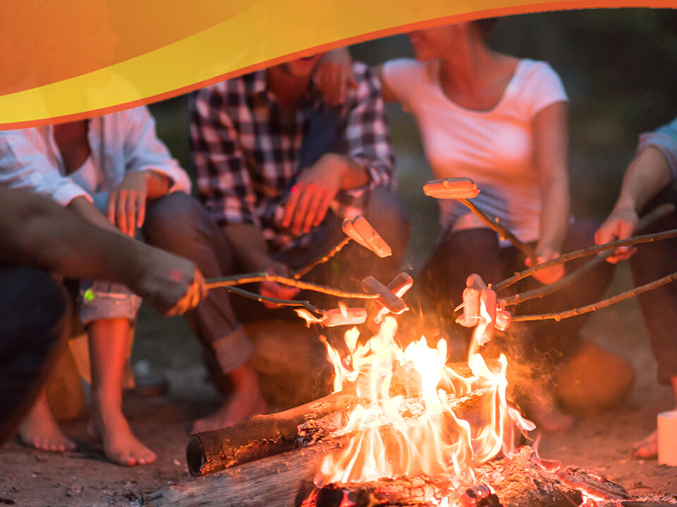 People sitting around a fire roasting marshmallows